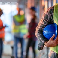 Man holding blue helmet