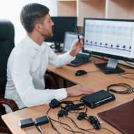 Vertical photo. Polygraph examiner works in the office with his lie detector’s equipment Vertical photo. Polygraph examiner works in the office with his lie detector's equipment.